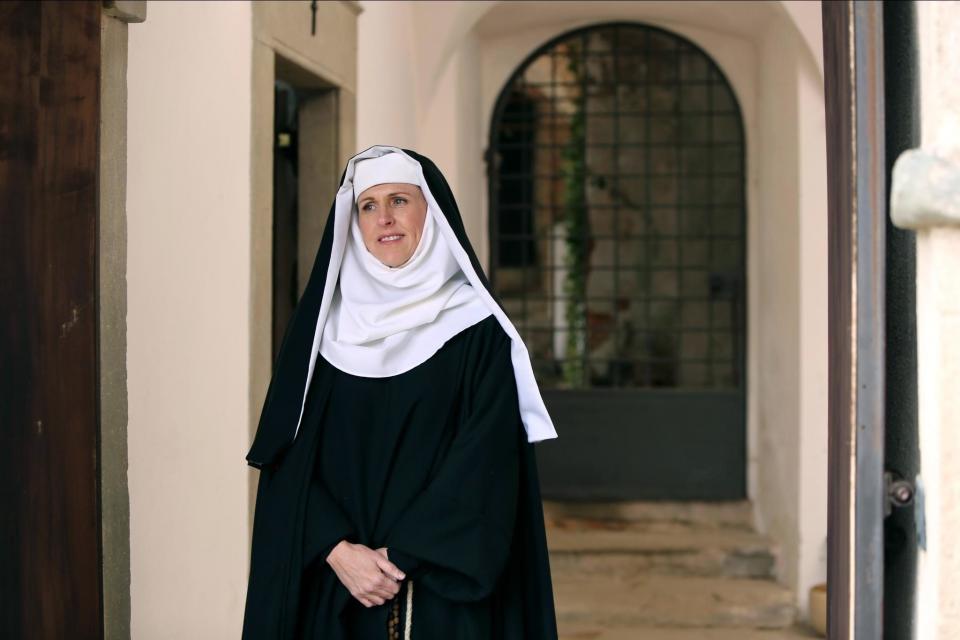 Molly Shannon stands dressed as a nun