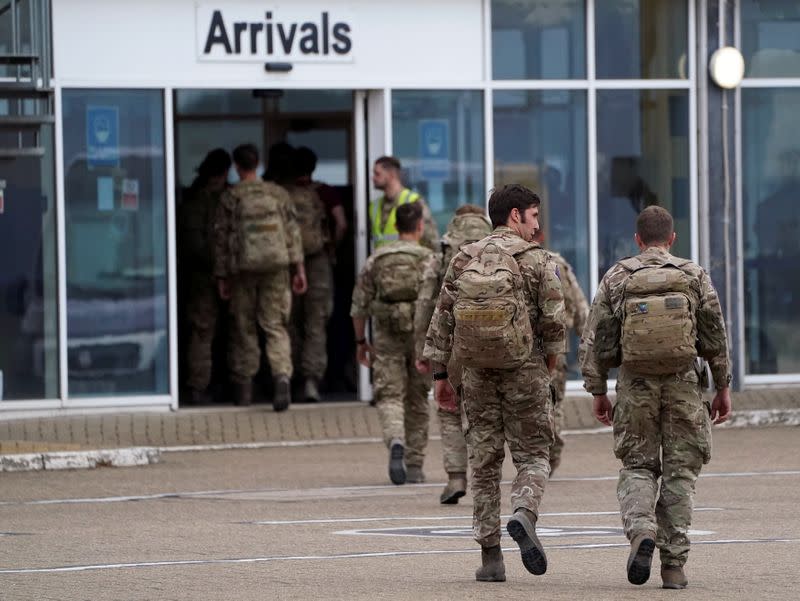 Members of the British armed forces arrive at RAF Brize Norton base