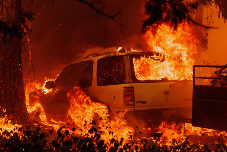 A car is engulfed in flames in Mariposa County, on July 23.<span class="copyright">Ethan Swope—San Francisco Chronicle/AP</span>