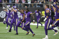 Minnesota Vikings players celebrate after winning an NFL match against New Orleans Saints at the Tottenham Hotspur stadium in London, Sunday, Oct. 2, 2022. The Vikings won the match 28-25. (AP Photo/Frank Augstein)