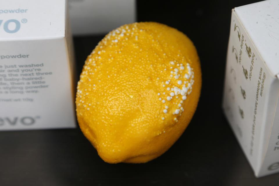 A damaged lemon is seen in the window of a barbers shop in London