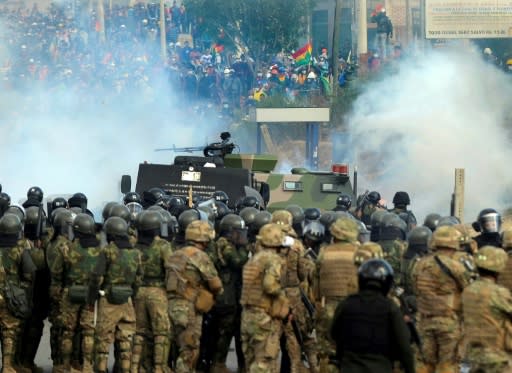 Bolivian riot police and soldiers clash with supporters of Bolivia's ex-President Evo Morales during a protest against the interim government in Sacaba, Chapare province, Cochabamba department on November 15, 2019