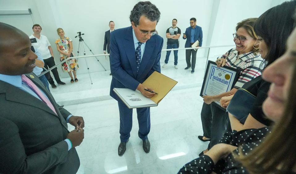 Santiago Calatrava, the architect who designed the Quadracci Pavilion at the Milwaukee Art Museum, autographs and creates artwork before gifting a book to Mayor Cavalier Johnson on Wednesday, Sept. 14, 2022, in downtown Milwaukee.