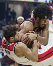 Cleveland Cavaliers' Jarrett Allen, top, and Washington Wizards' Raul Neto battle for a jump ball in the first half of an NBA basketball game, Wednesday, Nov. 10, 2021, in Cleveland. (AP Photo/Tony Dejak)