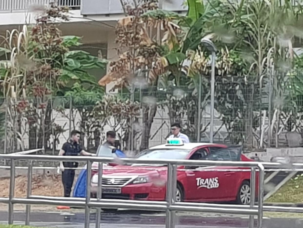 A blue tent seen next to a Trans-Cab vehicle parked at an open-air carpark in Hougang on 1 August, 2018. (PHOTO: Singapore Taxi Driver/Facebook)