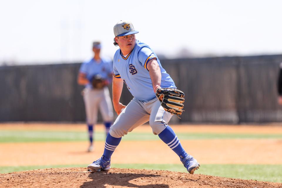Sunray’s Parker Johnson (11) pitches the ball in a District 1-2A game against Gruver, Friday, April 7, 2023, at Gruver High School, in Gruver, Texas.  Gruver won 7-6.