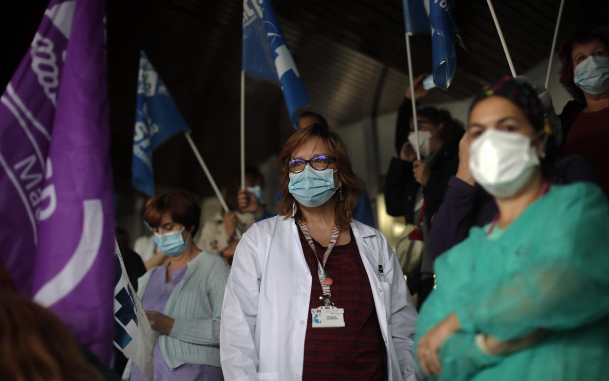 Spanish healthcare workers take part in a protest against work conditions, getting heavier due to coronavirus pandemic, and privatization in the health sector outside the Ramon y Cajal State Hospital in Madrid - Anadolu Agency /Anadolu 