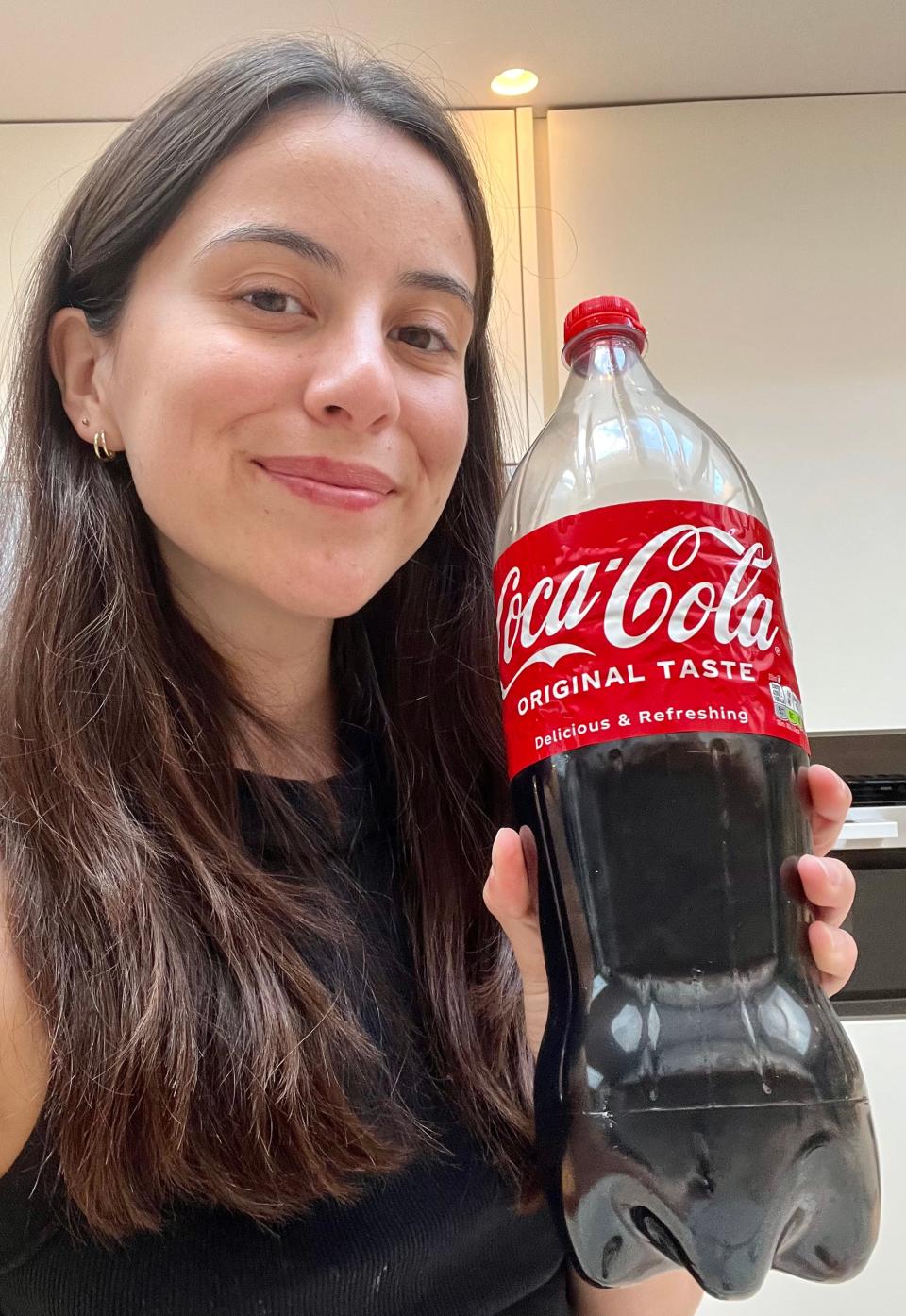 The author holding a large Coca-Cola bottle.