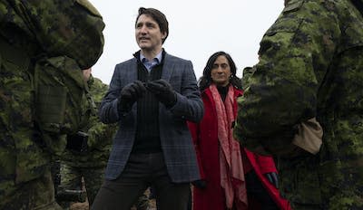 Canadian Prime Minister Justin Trudeau and Minister of Defence Anita Anand speak with Canadian troops deployed in Latvia in March 2022, shortly after Russia invaded Ukraine. THE CANADIAN PRESS/Adrian Wyld