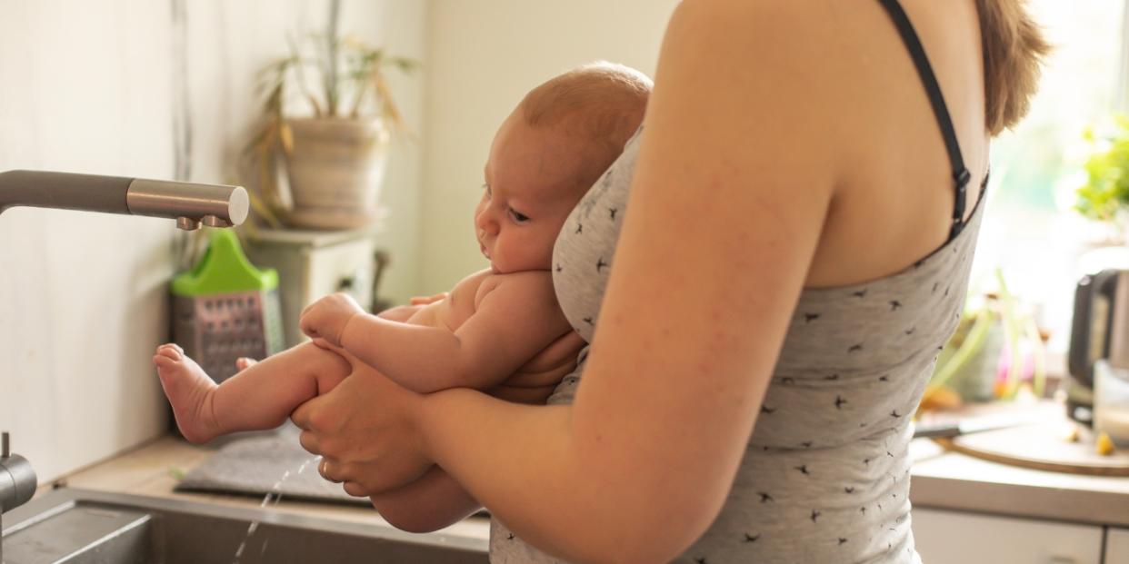 mom holding baby practicing elimination communication