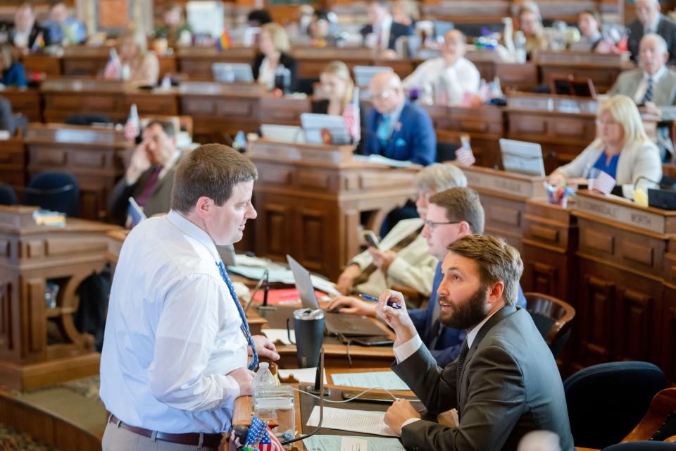 House Speaker Pat Grassley, R-New Hartford, left, speaks with state Rep. Bobby Kaufmann, R-Wilton, on the House floor at the Iowa State Capitol, Monday, May 1, 2023.