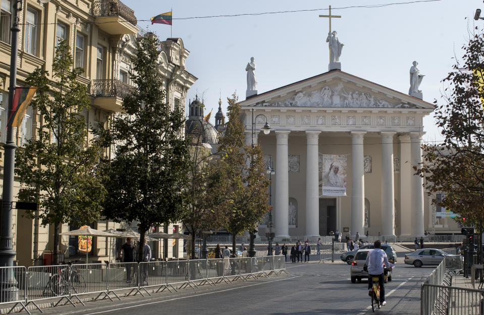 A photo of Pope Francis is hung in front of the Cathedral Basilica of St Stanislaus and St Ladislaus in Vilnius, Lithuania, Friday, Sept. 21, 2018, ahead of Pope Francis' upcoming visit to Lithuania. Pope Francis heads to Europe's northeastern peripheries this weekend to celebrate the faith in three Baltic countries amid renewed alarm about Russia's intentions in the region it twice occupied. (AP Photo/Mindaugas Kulbis)