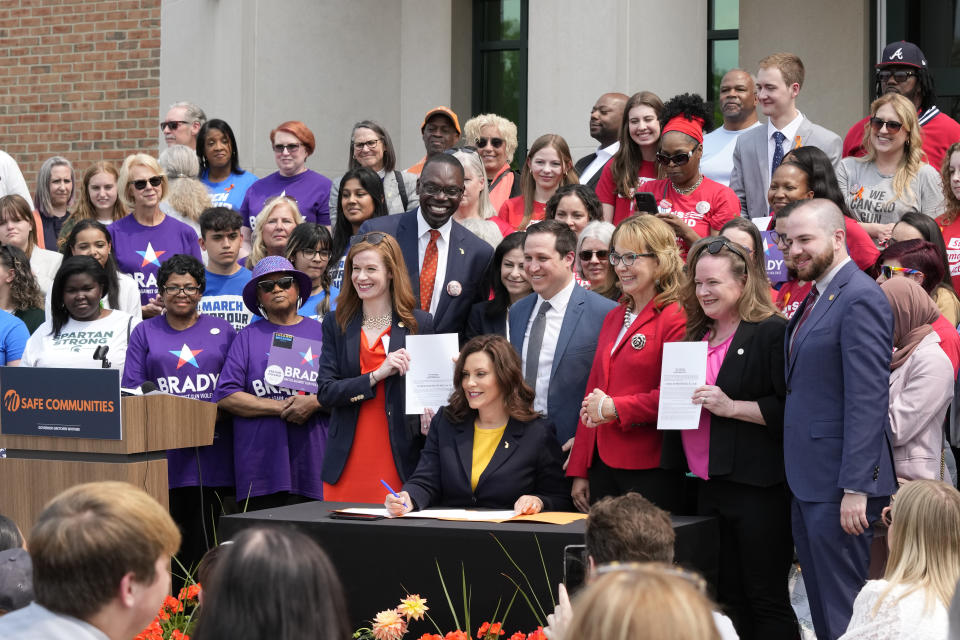 Michigan Gov. Gretchen Whitmer signs legislation, Monday, May 22, 2023, in Royal Oak, Mich. The package of legislation being signed will create extreme risk protection orders, which authorize family, police officers, or medical professionals to seek a court order to temporarily keep guns out of the hands of someone who represents a danger to themselves or others. (AP Photo/Carlos Osorio)