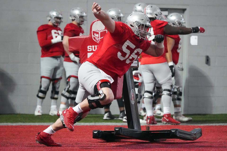 Mar 5, 2024; Columbus, OH, USA; Ohio State Buckeyes offensive lineman Seth McLaughlin (56) hits the sled during the first spring practice at the Woody Hayes Athletic Center.