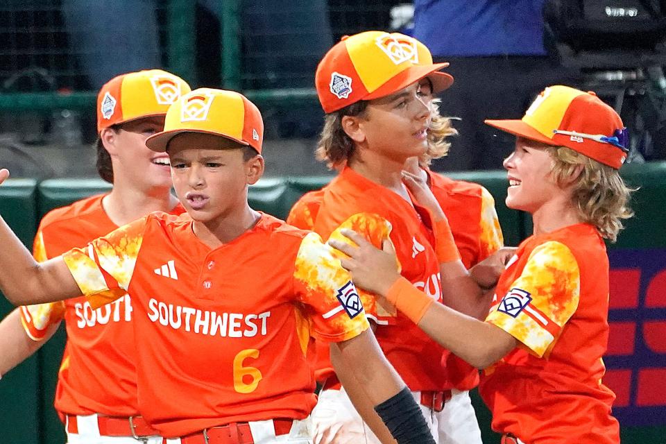 Needville, Texas' Jagger McRae, right, celebrates with DJ Jablonski, center right, after their win over El Segundo, Calif., in a baseball game at the Little League World Series tournament in South Williamsport, Pa., Monday, Aug. 21, 2023. (AP Photo/Tom E. Puskar) ORG XMIT: PATP162