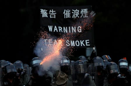 FILE PHOTO: Police fire tear gas at a demonstration in support of the city-wide strike and to call for democratic reforms at Tai Po residential area in Hong Kong