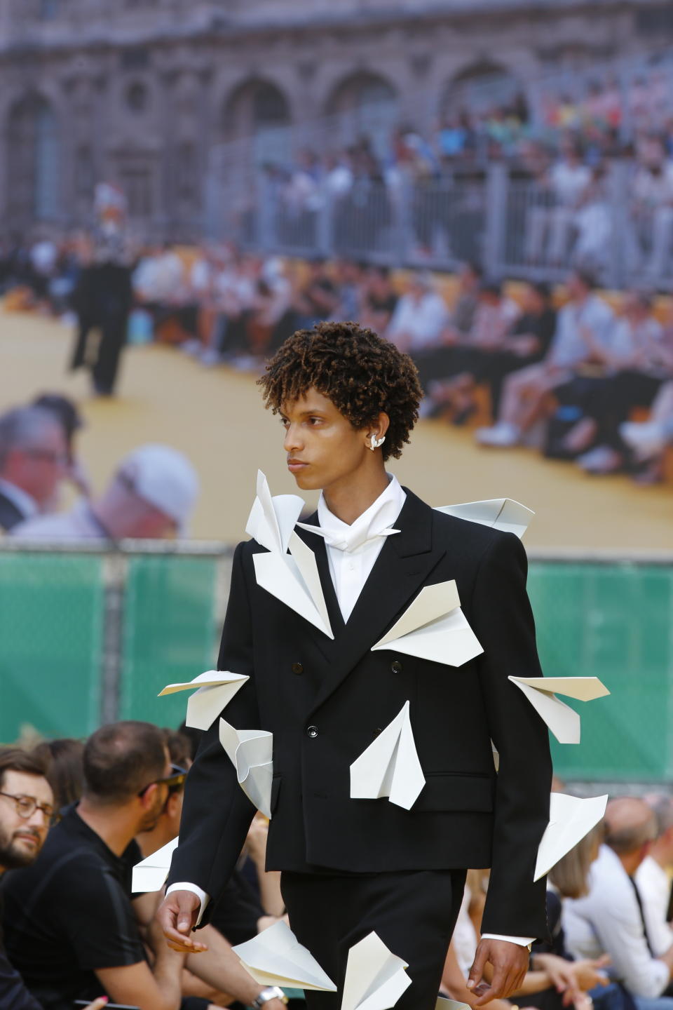 Origami paper planes on a cropped suit at Louis Vuitton spring summer ’23 menswear. - Credit: JAVA-FASHION