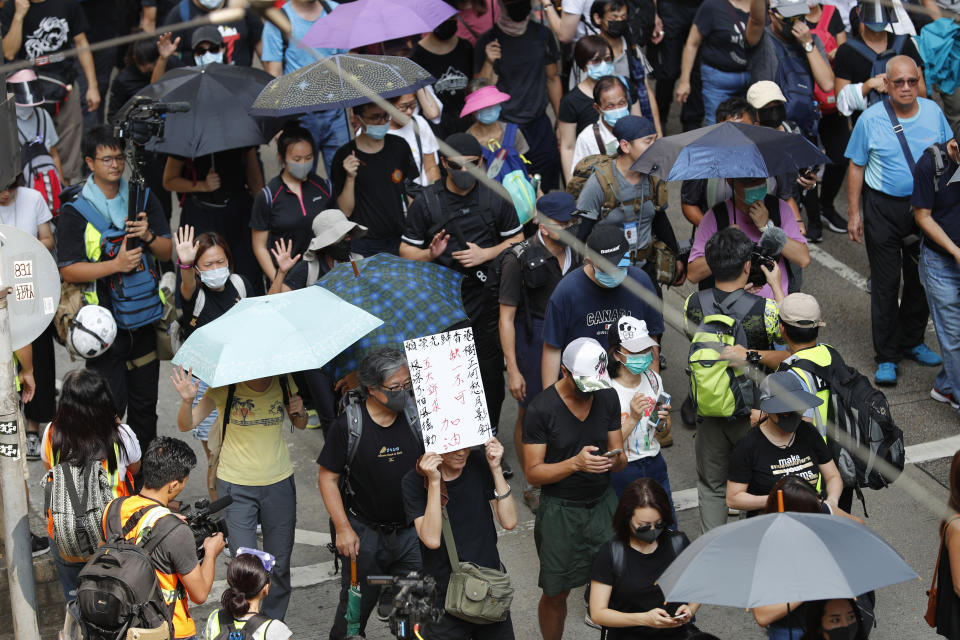 Masked protesters march in Hong Kong on Saturday, Oct. 5, 2019. All subway and trains services are closed in Hong Kong after another night of rampaging violence that a new ban on face masks failed to quell. (AP Photo/Vincent Thian)
