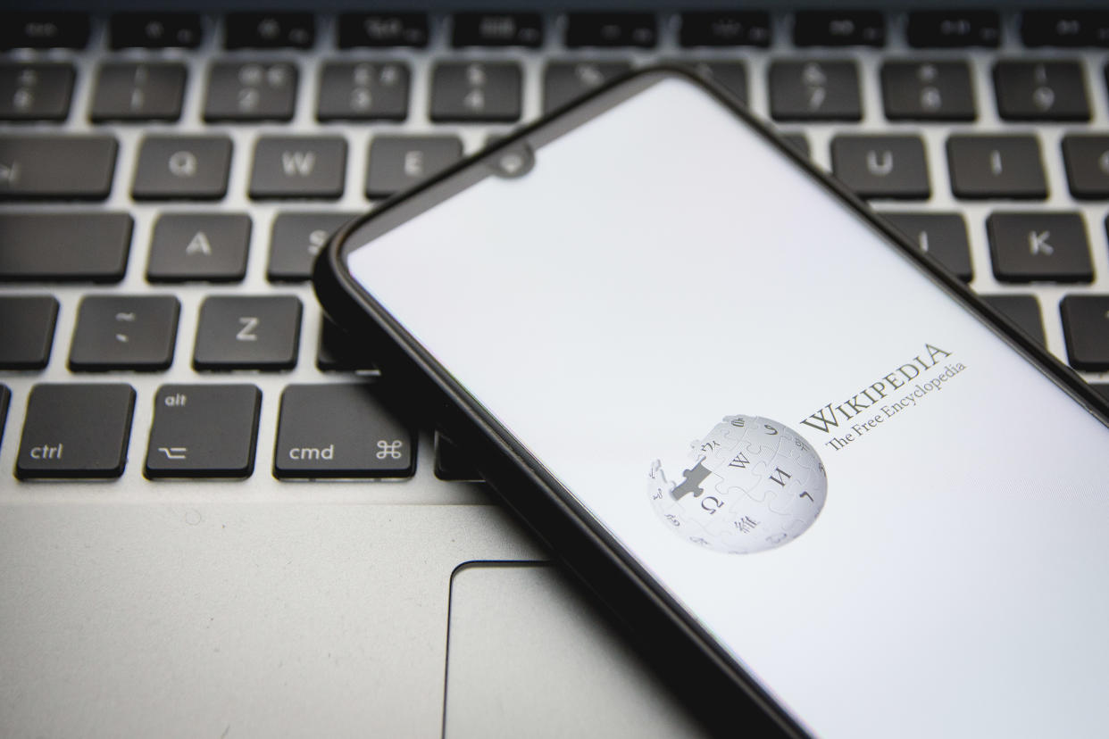 In this photo illustration a Wikipedia logo seen displayed on a smartphone screen with a computer keyword in the background in Athens, Greece on December 12, 2021. (Photo by Nikolas Kokovlis/NurPhoto via Getty Images)