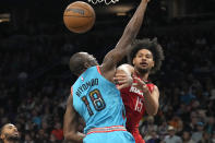 Houston Rockets guard Daishen Nix passes the ball around Phoenix Suns center Bismack Biyombo (18) during the first half of an NBA basketball game Friday, Dec. 2, 2022, in Phoenix. (AP Photo/Rick Scuteri)