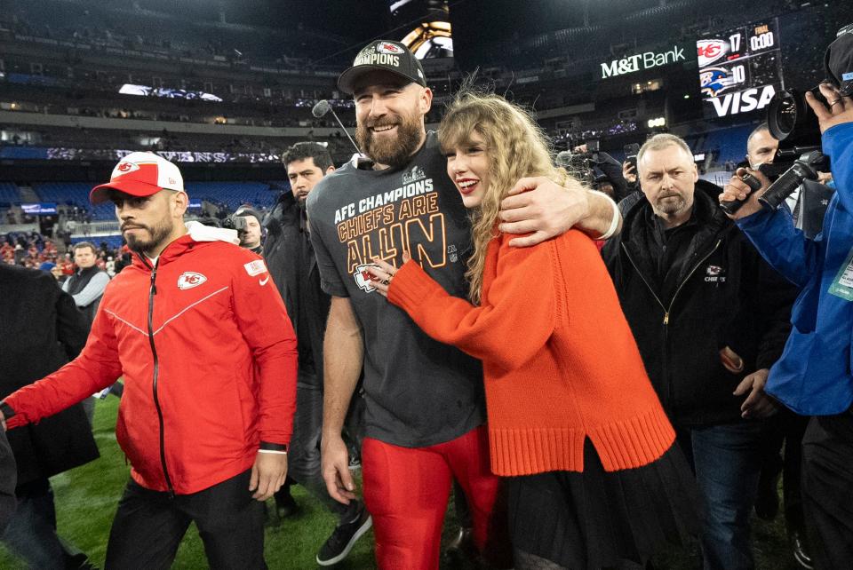Travis Kelce and Taylor Swift walk together after an AFC Championship NFL football game, Jan. 28, 2024, in Baltimore. Scrutiny over Swift’s travel has been bubbling up online, with people pointing out the planet-warming emissions of carbon dioxide released with every flight.