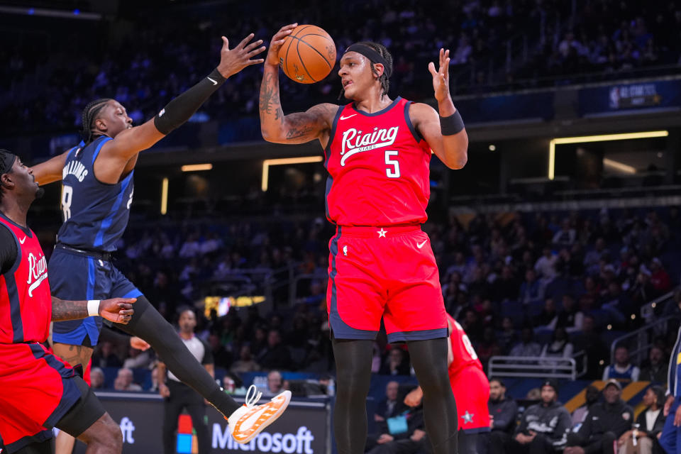 Paolo Banchero of the Orlando Magic grabs a rebounds in front of Jalen Williams of the Oklahoma City Thunder during an NBA Rising Stars basketball game in Indianapolis, Friday, Feb. 16, 2024. (AP Photo/Michael Conroy)