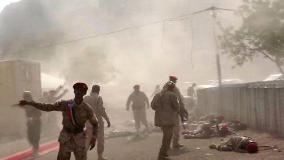 This AFPTV screen grab from a video made on August 1, 2019, shows Yemeni security forces rushing at the scene of a missile attack on a military camp west of Yemen’s government-held second city Aden (Nabil HASAN / AFP)