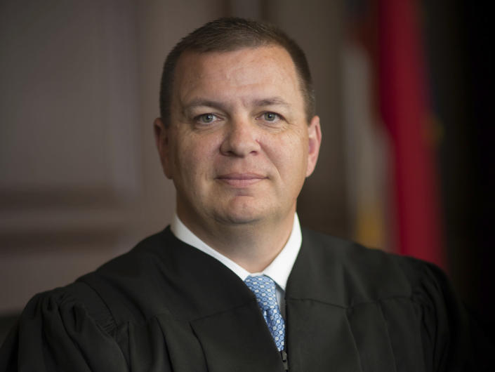This photo provided by North Carolina Administrative Office of the Courts shows Associate Justice Phil Berger Jr. One of several legal challenges to North Carolina’s contentious voter ID law is on hold amid a dispute over whether two justices on the state Supreme Court — one the son of arguably the state's most powerful Republican politician — should recuse themselves. (North Carolina Administrative Office of the Courts via AP)