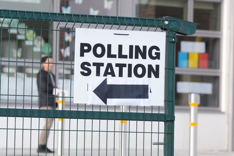 Polling station sign attached to a fence,