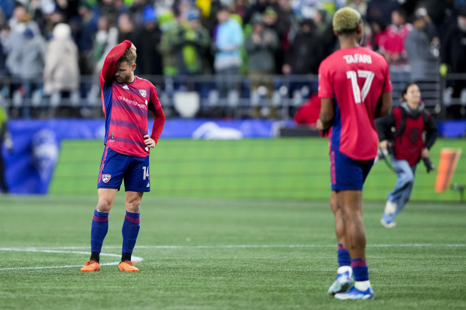 FC Dallas midfielder Asier Illarramendi, left, and defender Nkosi Tafari (17) stand on the pitch after the team was eliminated with a 1-0 loss to the Seattle Sounders in Game 3 of a first-round MLS playoff soccer series Friday, Nov. 10, 2023, in Seattle. (AP Photo/Lindsey Wasson)