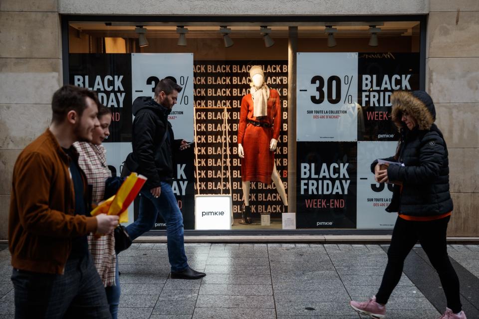 Pedestrians walk past a shop announcing Black Friday sales in Caen, northwestern France, on November 27, 2019. - Black Friday is a sales offer originating from the US where retailers slash prices on the day after the Thanksgiving holiday. (Photo by Sameer Al-DOUMY / AFP) (Photo by SAMEER AL-DOUMY/AFP via Getty Images)