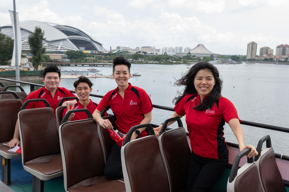 Top Singapore athletes of the year - (from left) Aloysius Yapp, Loh Kean Yew, Shayna Ng and Yip Pin Xiu - atop their open-top bus parade as it passes the Singapore Sports Hub. (PHOTO: Sport Singapore)