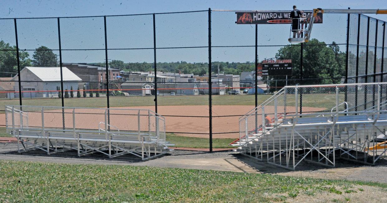 Workers hang a final sign at the new Dalton High School softball field. A dedication ceremony will be held at 6 p.m. July 12 with a game between current players and program alumni shortly after.