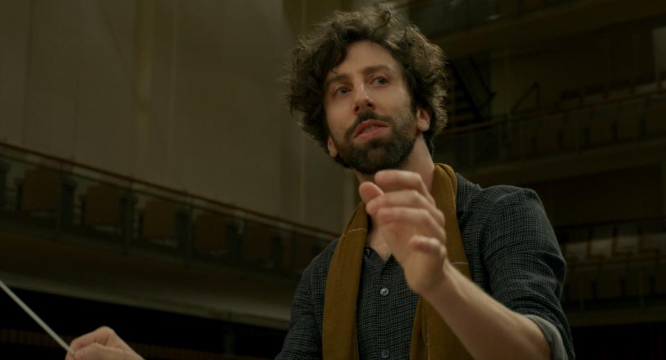 Simon Helberg plays the Conductor, a musician who regrets not revealing his feelings to a longtime love in "Annette."