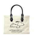 <p>To celebrate ‘Peanuts’’ 60th anniversary back in 2010, the bag designer created several accessories with the loveable Snoopy emblazoned on them.<em> [Photo: Longchamp]</em> </p>