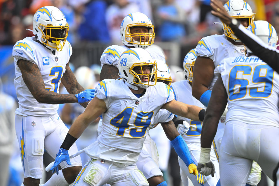 Los Angeles Chargers linebacker Drue Tranquill (49) celebrates with teammates after stopping the Cleveland Browns on a fourth down and getting the ball back for the offense during the second half of an NFL football game, Sunday, Oct. 9, 2022, in Cleveland. (AP Photo/David Richard)