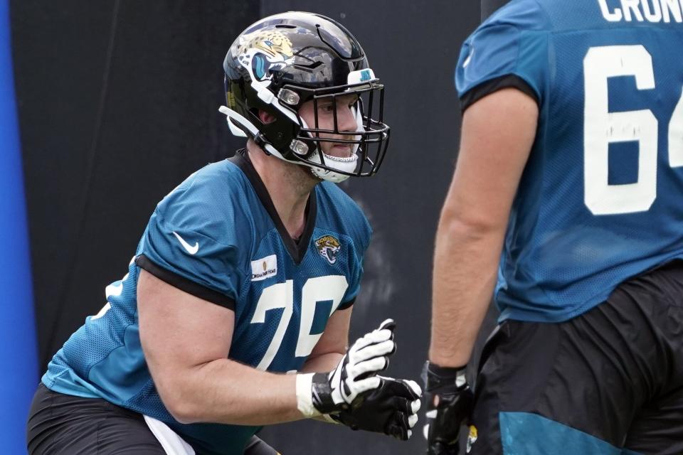 Jacksonville Jaguars Luke Fortner, left, performs a drill during the NFL football team's rookie minicamp, Saturday, May 14, 2022, in Jacksonville, Fla. (AP Photo/John Raoux)