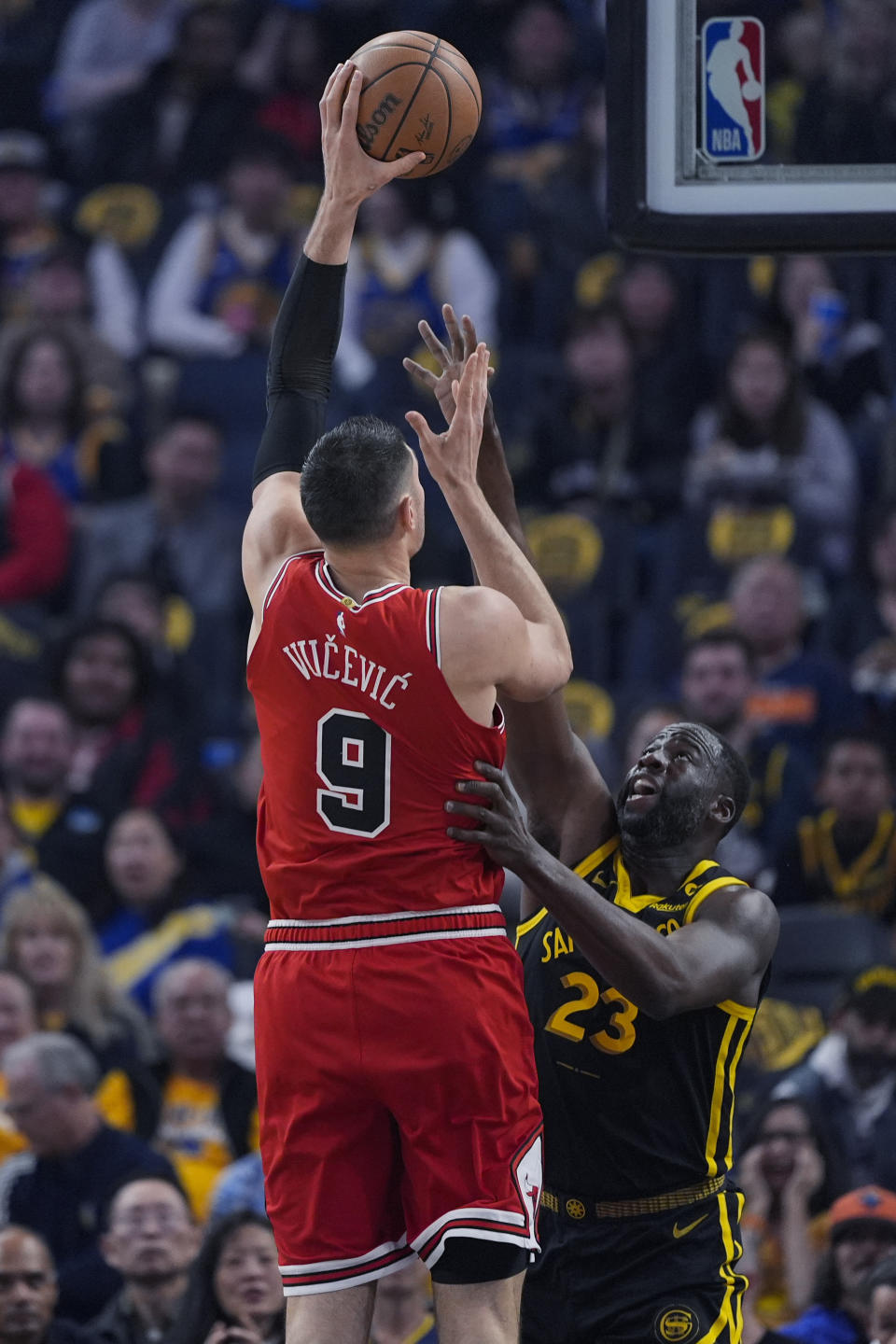 Chicago Bulls center Nikola Vucevic, left, shoots over Golden State Warriors center Draymond Green during the first half of an NBA basketball game Thursday, March 7, 2024, in San Francisco. (AP Photo/Godofredo A. Vásquez)