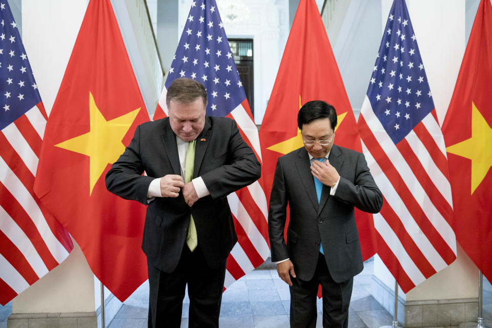 FILE - In this July 9, 2018, file photo, U.S. Secretary of State Mike Pompeo, left, and Vietnamese Deputy Prime Minister and Foreign Minister Pham Binh Minh arrive for photos before a meeting at the Ministry of Foreign Affairs in Hanoi, Vietnam. Vietnam's selection as the venue for the second summit between U.S. President Donald Trump and North Korean leader Kim Jong Un is largely a matter of convenience and security, but not without bigger stakes. (AP Photo/Andrew Harnik, Pool, File)