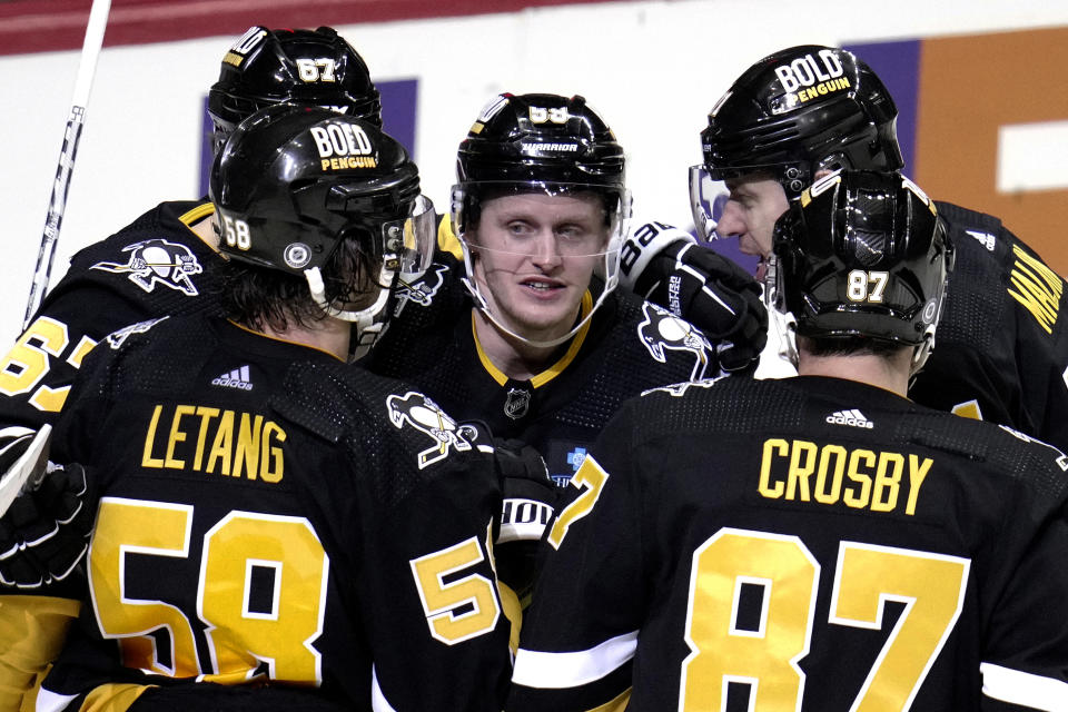 Pittsburgh Penguins' Jake Guentzel (59) celebrates his goal against the Nashville Predators during the third period of an NHL hockey game in Pittsburgh, Thursday, March 30, 2023. (AP Photo/Gene J. Puskar)