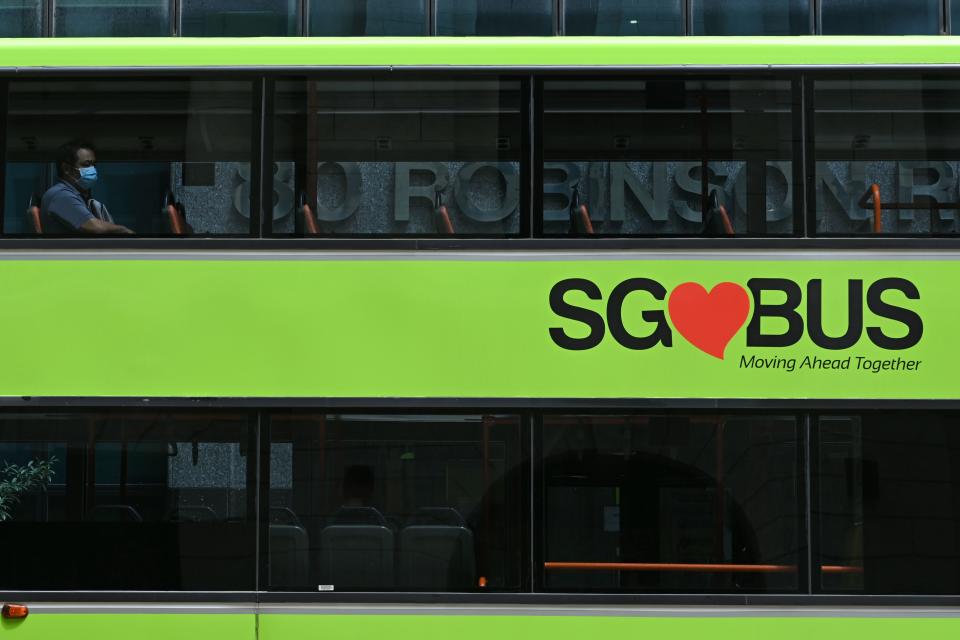 A lone commuter sits in the top deck of a public bus in Singapore on 7 April, 2020. (PHOTO: AFP via Getty Images)