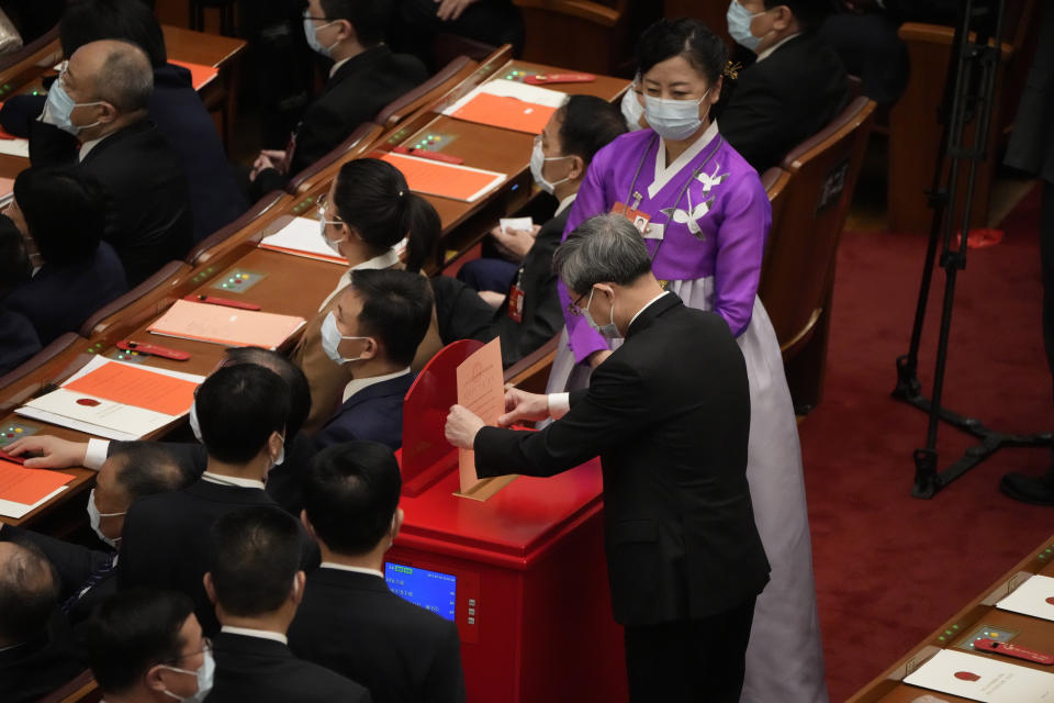 A delegate casts his vote during a session of China's National People's Congress (NPC) to select state leaders at the Great Hall of the People in Beijing, Friday, March 10, 2023. (AP Photo/Mark Schiefelbein)