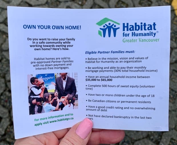 Shahra-sad Mohamed Warsame Ali and her family are pictured in a pamphlet for Habitat for Humanity. The photo captures the day they received a box with the 'key of hope' to their new Burnaby home.  