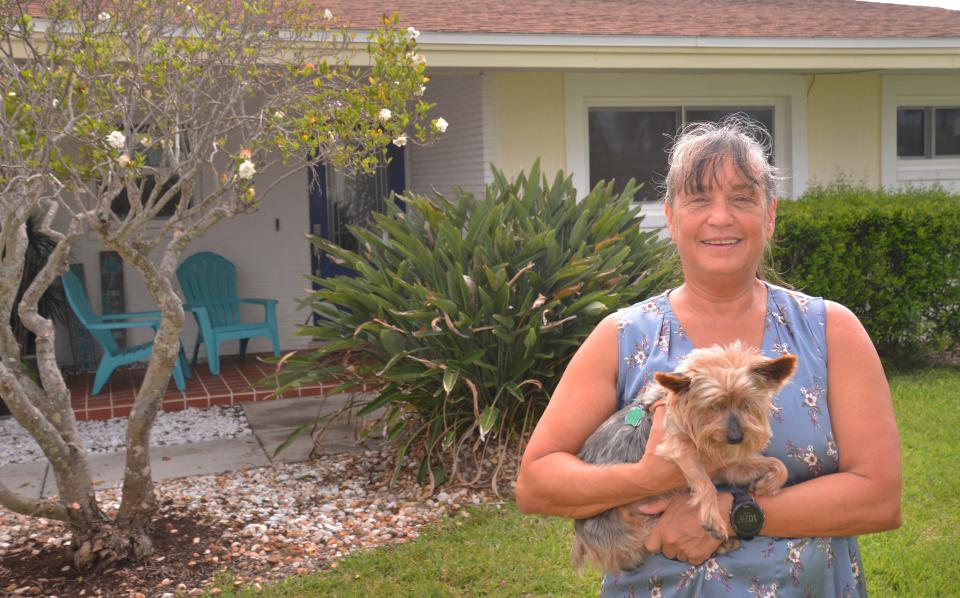 Zena Courtney, holding Basil, converted a single-family home in the residential neighborhood off Minutemen Causeway into a vacation rental. She said vacation rentals help support the local economy.