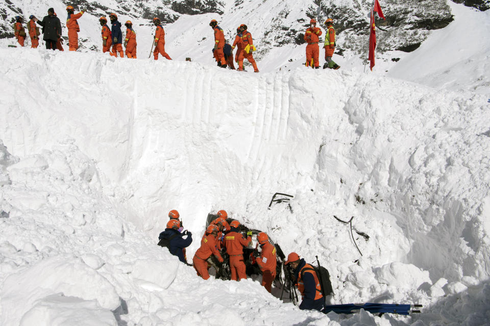 In this photo released by Xinhua News Agency, Rescuers search for survivors following an avalanche in Nyingchi, southwest China's Tibet Autonomous Region on Friday, Jan. 20, 2023. More bodies were found Friday following an avalanche that buried vehicles outside a highway tunnel in Tibet, raising the death toll more than a dozen with several people still missing. (Sun Fei/Xinhua via AP)