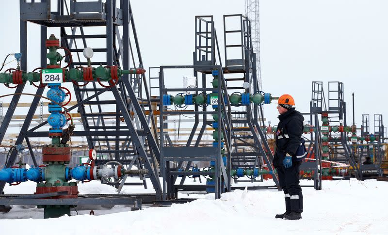 An employee inspects a well head in the Irkutsk Oil Company-owned Yarakta Oil Field in Irkutsk Region.