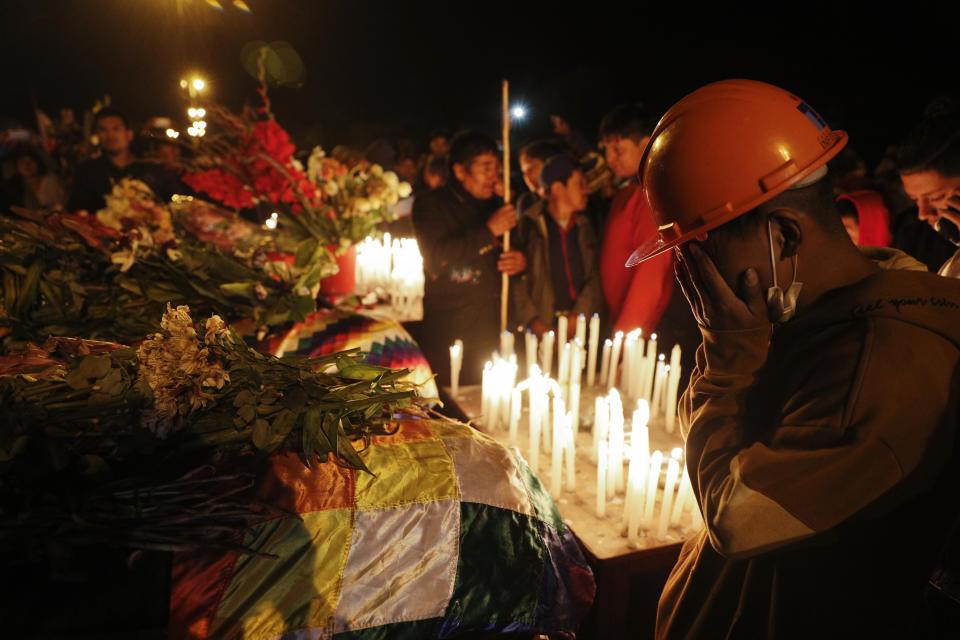 Mourners gather around coffins of backers of former President Evo Morales killed during clashes with security forces in Sacaba, Bolivia, Friday, Nov. 15, 2019. Bolivian security forces clashed with Morales' backers leaving at least five people dead, dozens more injured and escalating the challenge to the country's interim government to restore stability. (AP Photo/Juan Karita)