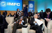 Bank of Japan Governor Haruhiko Kuroda chats with an aide as South Africa's Finance Minister Malusi Gigaba waits for the start of the International Monetary and Financial Committee (IMFC) Meeting, as part of the IMF and World Bank's 2017 Annual Spring Meetings, in Washington, U.S., April 22, 2017. REUTERS/Mike Theiler