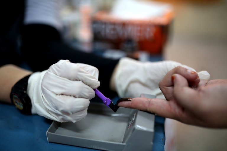 A Malaysian armed forces officer has her finger marked with ink before voting during an early vote for the general elections, at a military base in Kuala Lumpur, on April 30, 2013. The ruling coalition headed by the United Malays National Organisation is among the world's longest-serving governments, unbeaten since independence in 1957 thanks to decades of economic growth and authoritarian rule