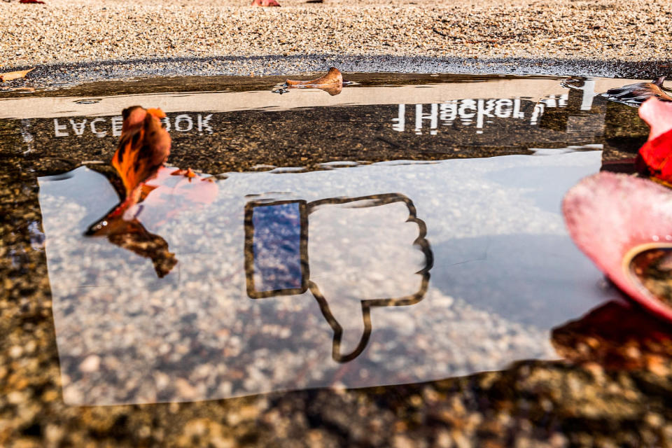 The Facebook logo reflected in a puddle at the company's headquarters in Menlo Park, Calif., on Oct. 25, 2021. (David Paul Morris / Bloomberg via Getty Images file)